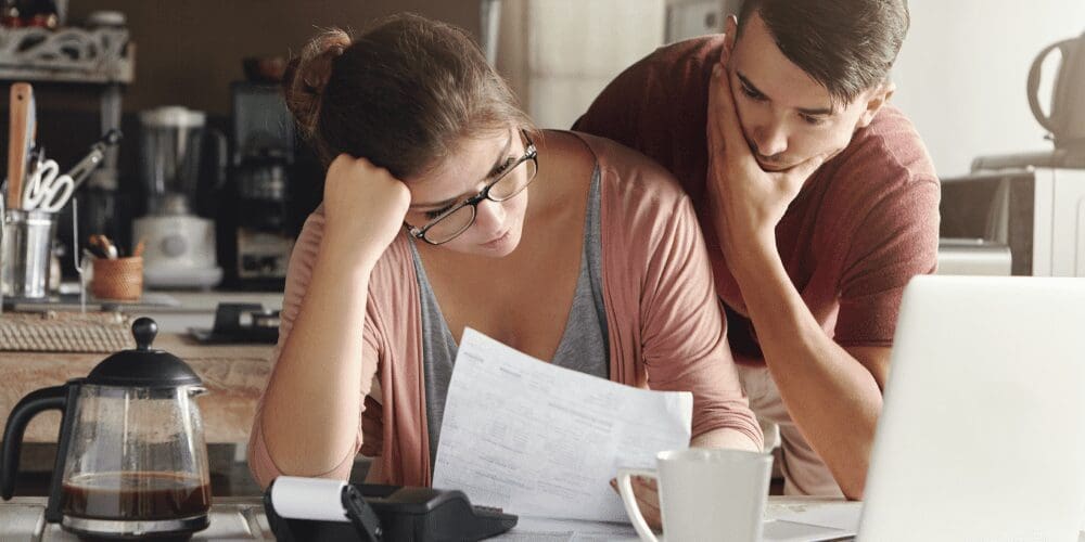 A couple looking at papers showing stress