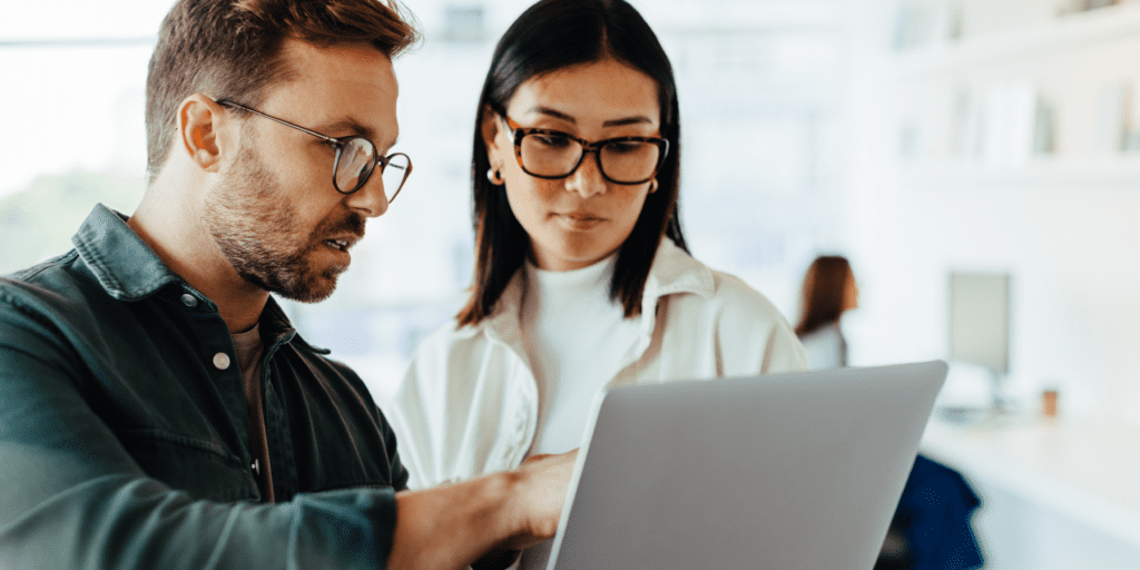 two people looking at a computer