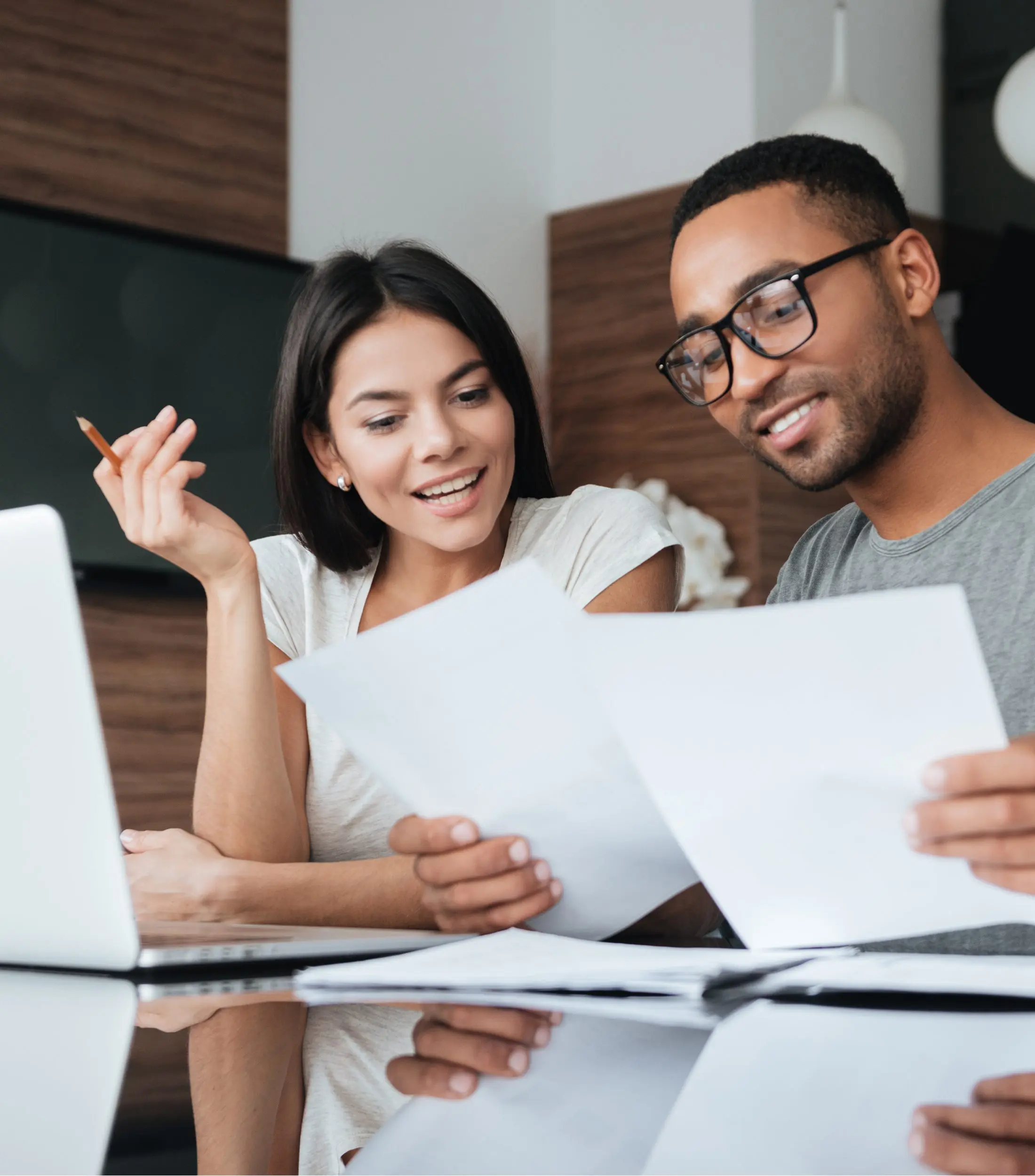 Couple Using Laptop and Analyzing Their Documents