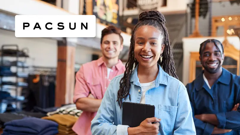 PacSun Case Study Resource Image - Portrait of Smiling Multi-Cultural Sales Team in Fashion Store in Front of Clothing Display