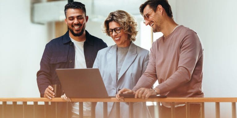 Happy Business People Video Calling Their Associates on a Laptop