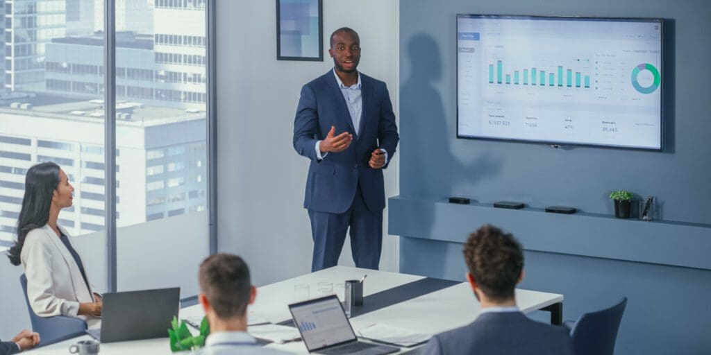 Office Conference Room Meeting Charismatic Businessman Presents Product to a Group of Investors