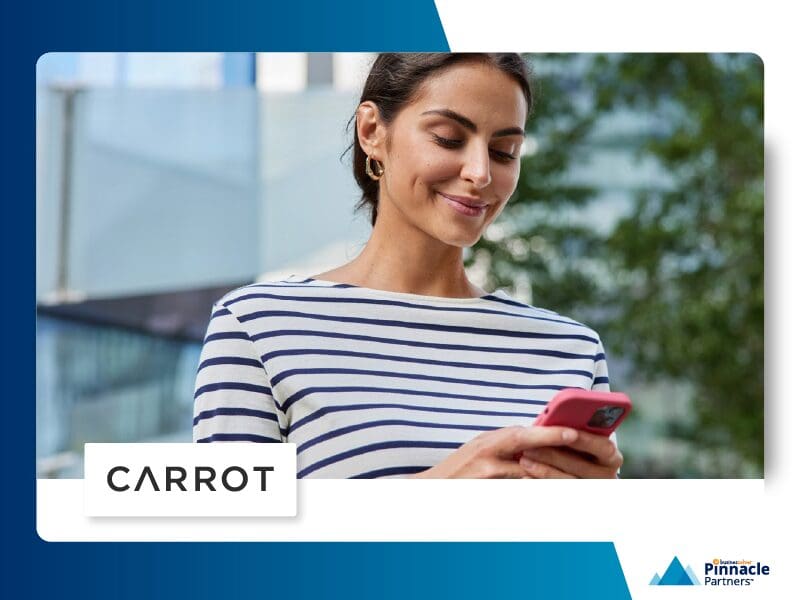 Woman smiling while looking at cell phone