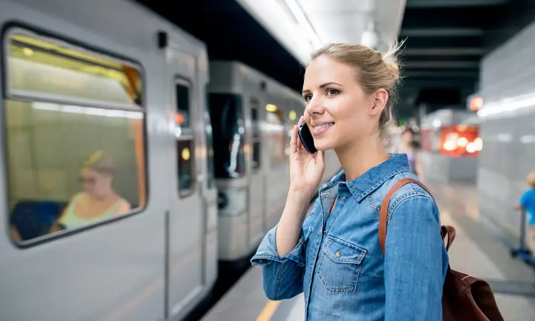 Woman Waiting and Making Phone Call at the Underground Train Station