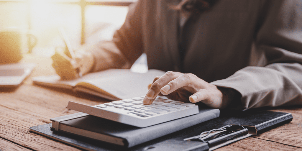 Person at home with laptop notebook and calculator