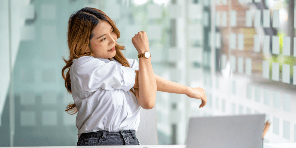 Woman stretching at her desk