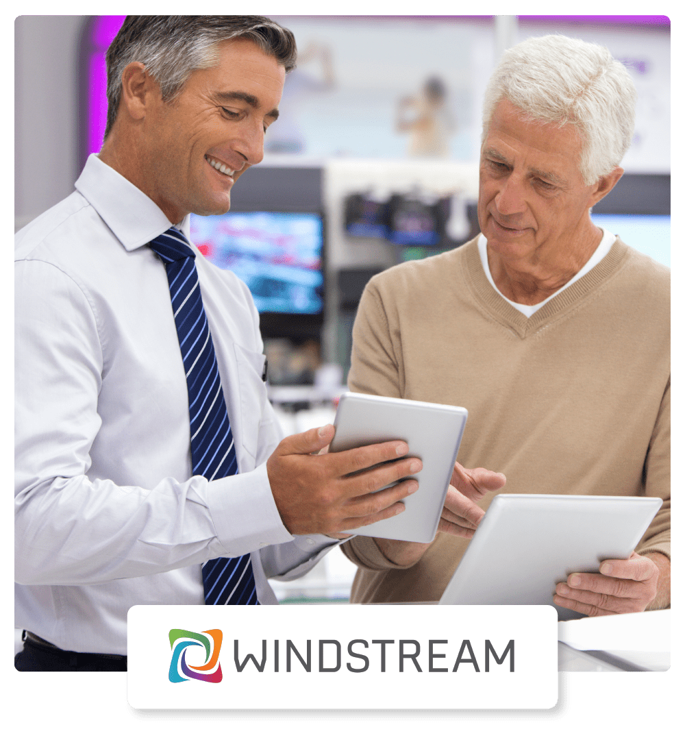 Windstream Case Study Hero - Happy Customers Ready to Sign Documents With Customer Service Representation