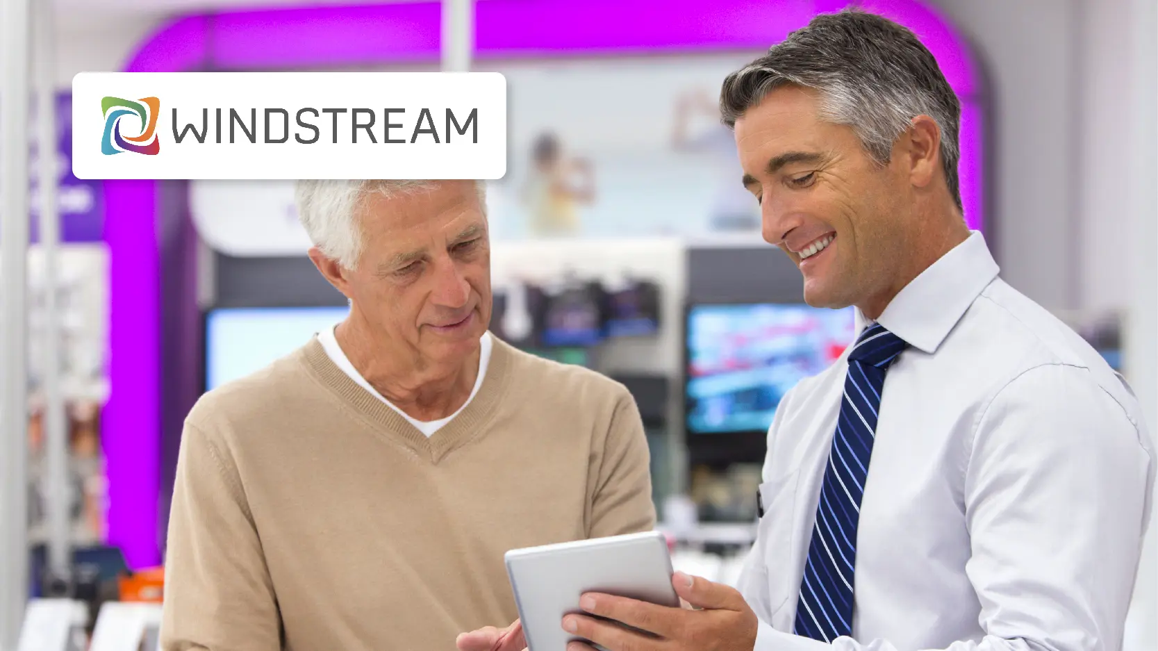 Windstream Case Study Resource Image - A Salesman Showing a Digital Tablet to an Elderly Man in an Telecommunications Store