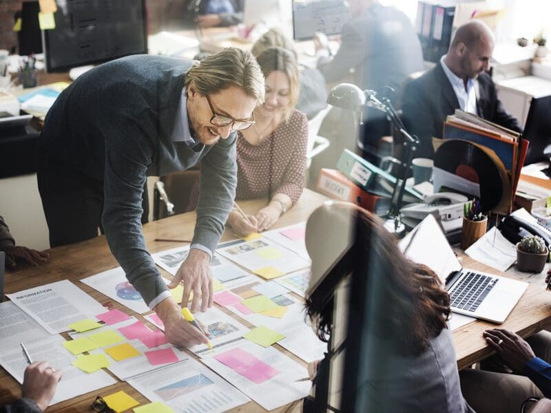 Employees strategizing in the office together