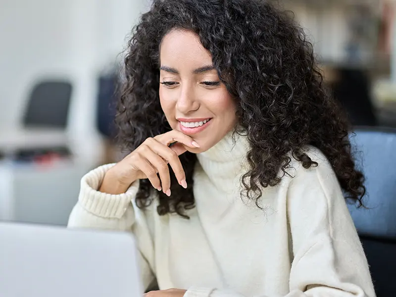 Woman smiling at laptop