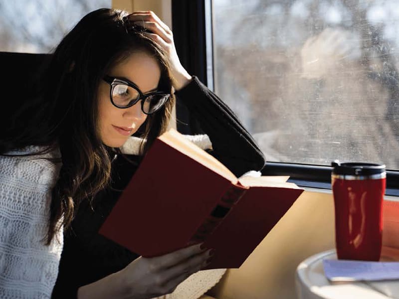 Woman reading on train
