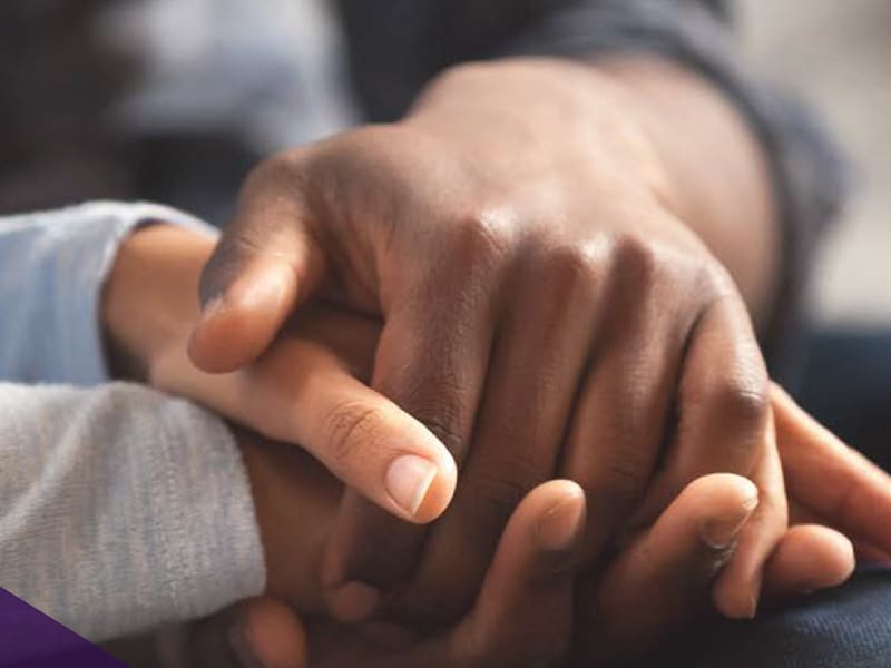 close up of two people holding hands