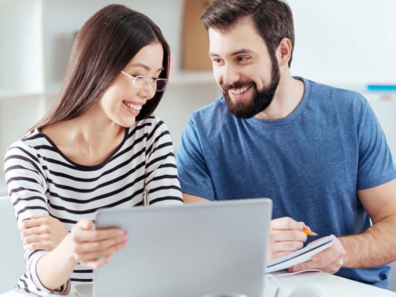 Man and woman using laptop