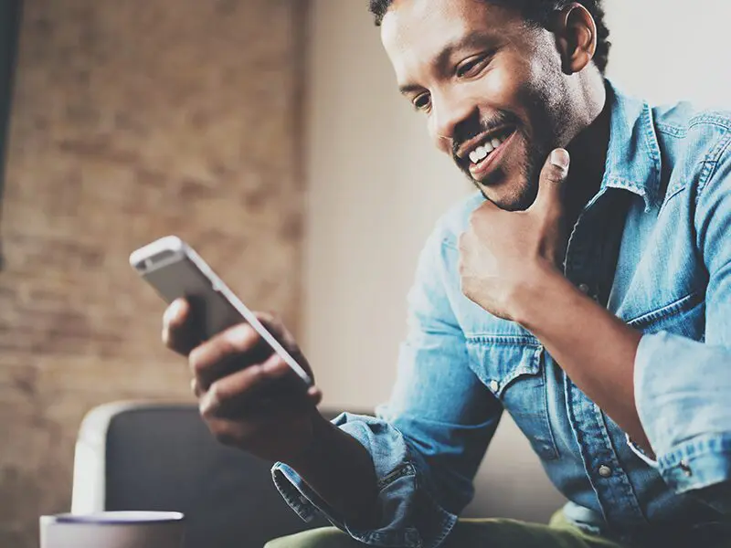 Man looking at mychoice mobile app on mobile phone