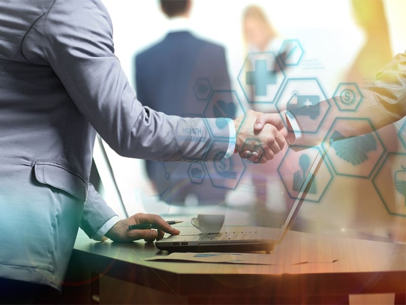 Two Businessman Shaking Hands in the Office – Resource Thumbnail