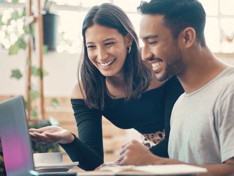 Happy, Smiling, Cheerful Man and Woman Browsing the Internet on a Laptop Inside a Coffee Shop – Resource Thumbnail