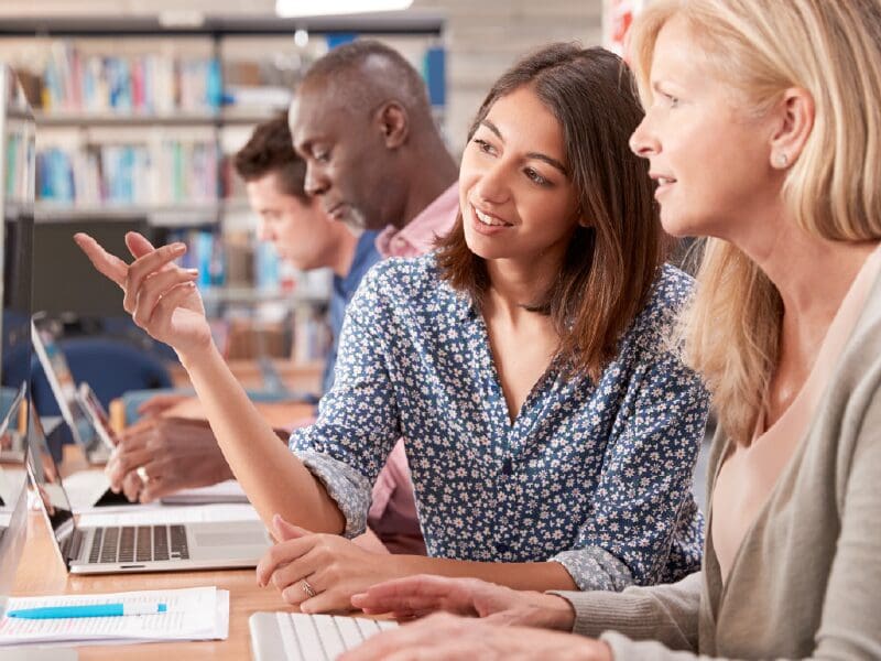 People working together to navigate what is on the computer screen