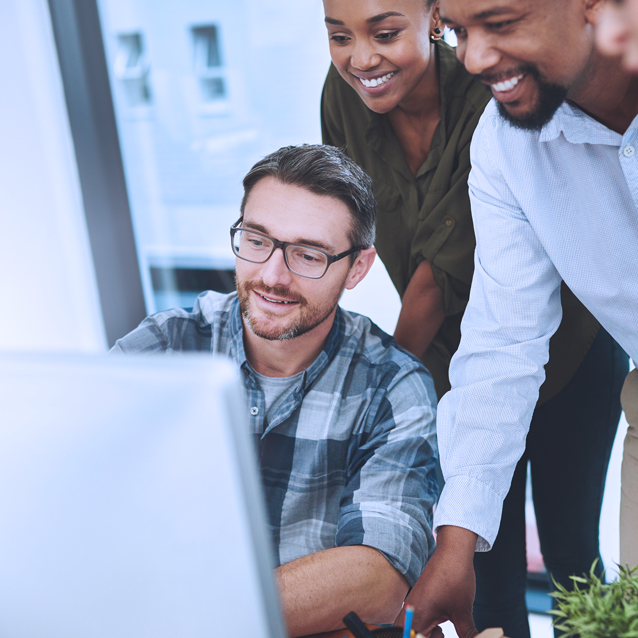 Group of people looking at a computer