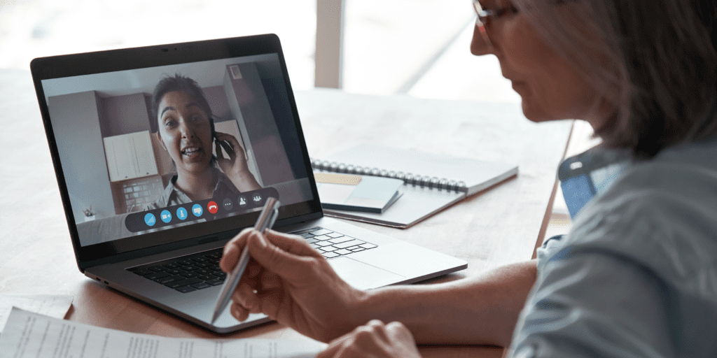 woman in a video chat taking notes