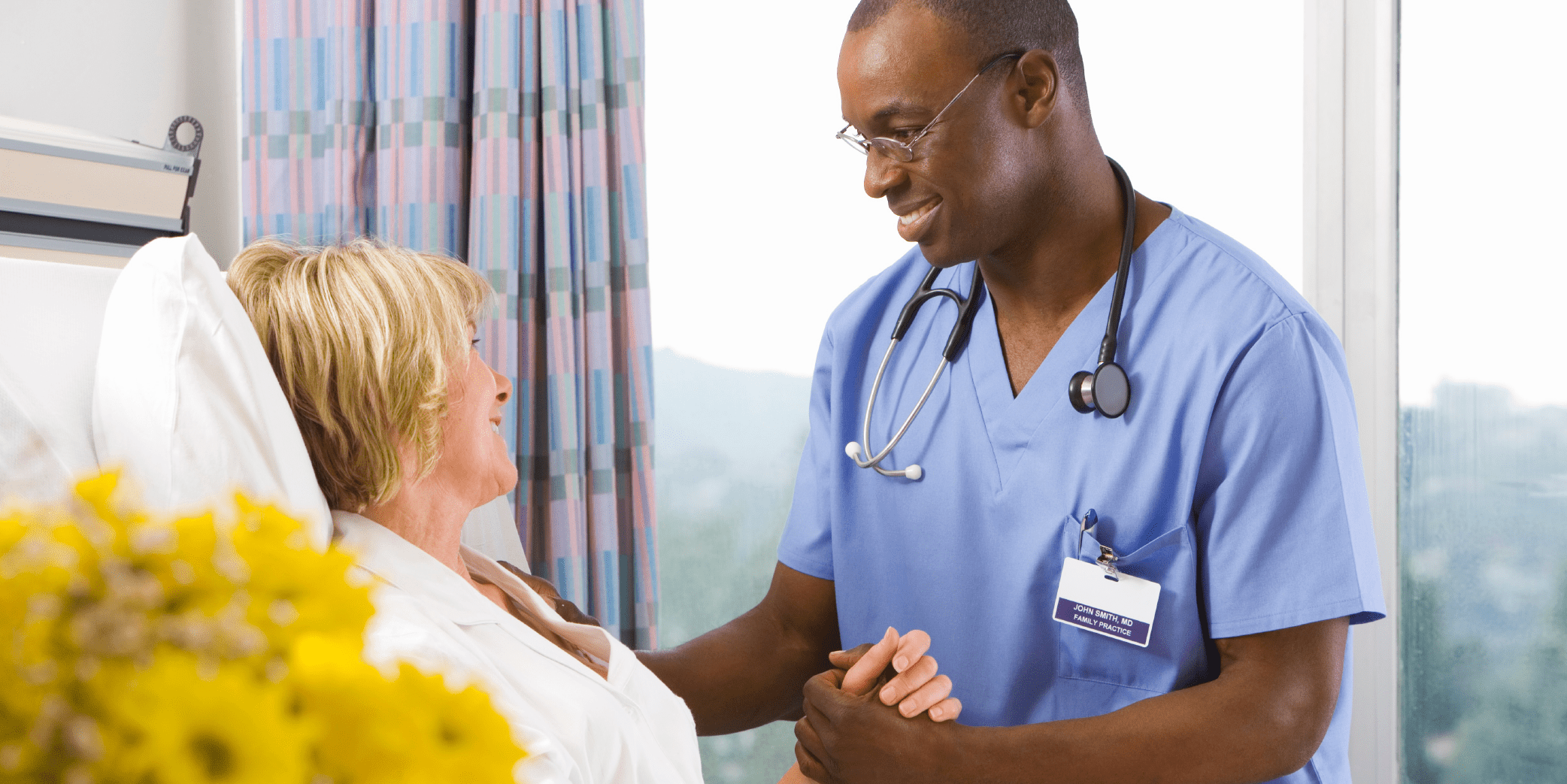 A nurse and a patient shake hands, symbolizing trust and care in a healthcare setting.