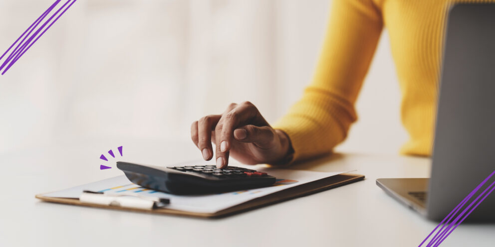 Accountant Working on Desk Using Calculator to Calculate Financial Report in Office