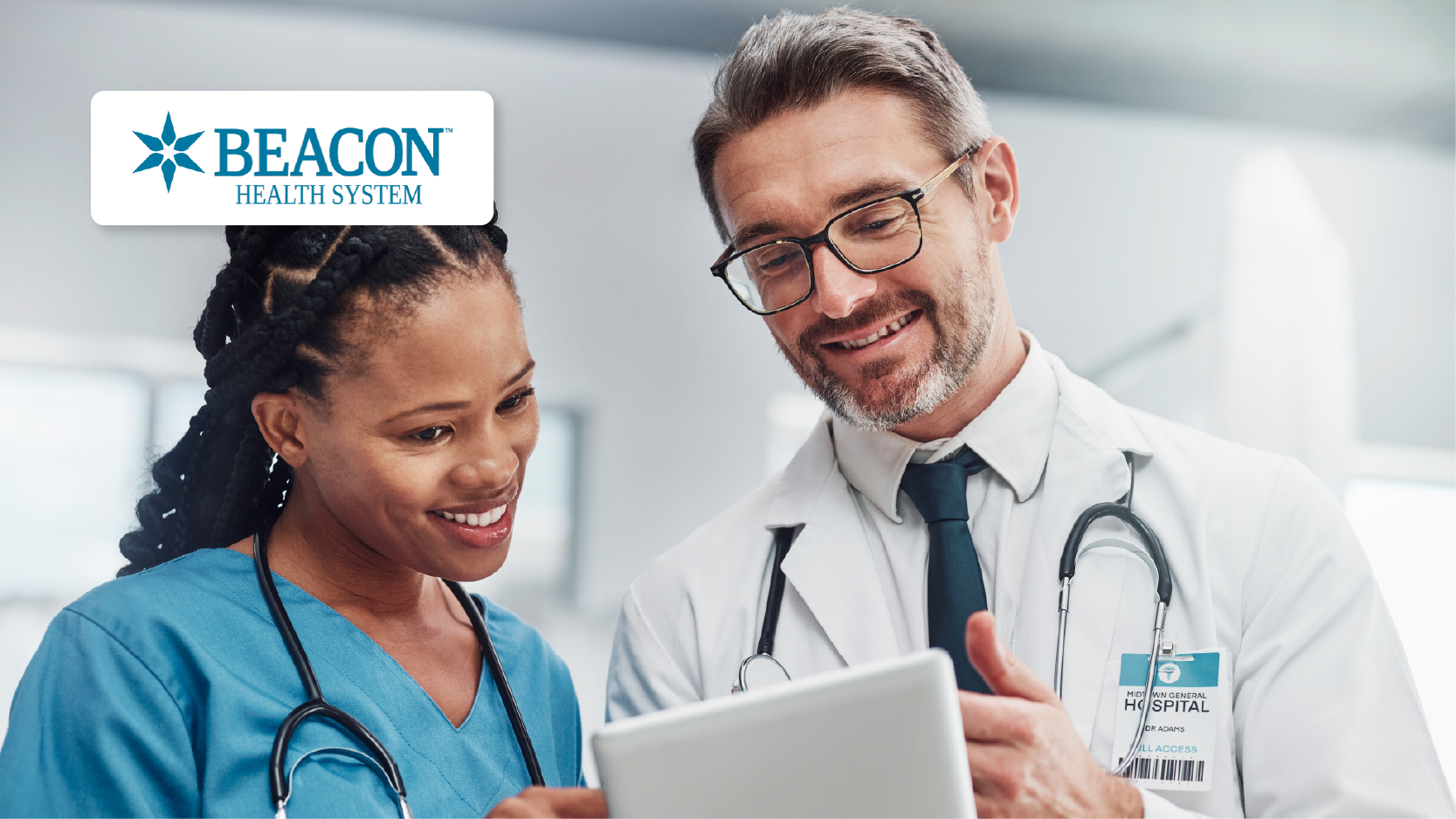 Beacon Health System – Healthcare, Research, and Doctors Holding Tablet Having a Conversation in Hospital