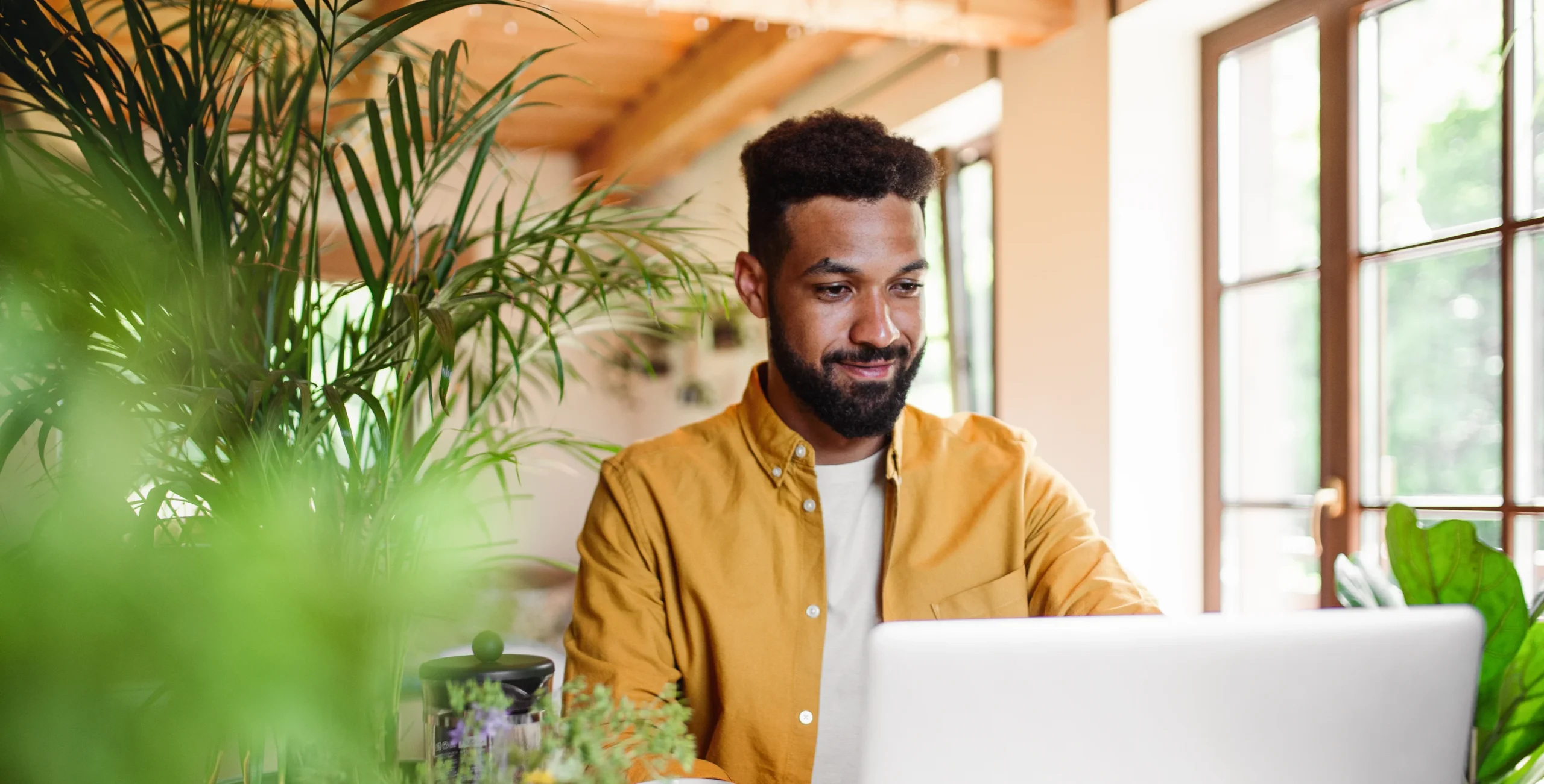 young man with laptop and coffee