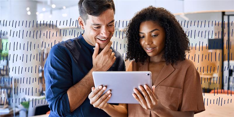 two people looking a a tablet