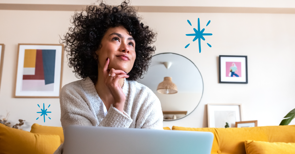 Young woman feeling accomplished, working on her laptop during enrollment season